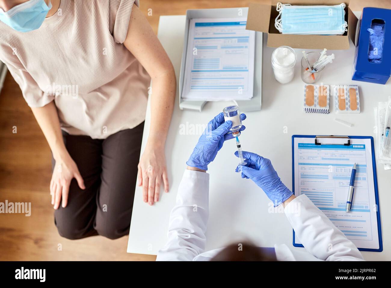 female doctor with syringe vaccinating patient Stock Photo - Alamy
