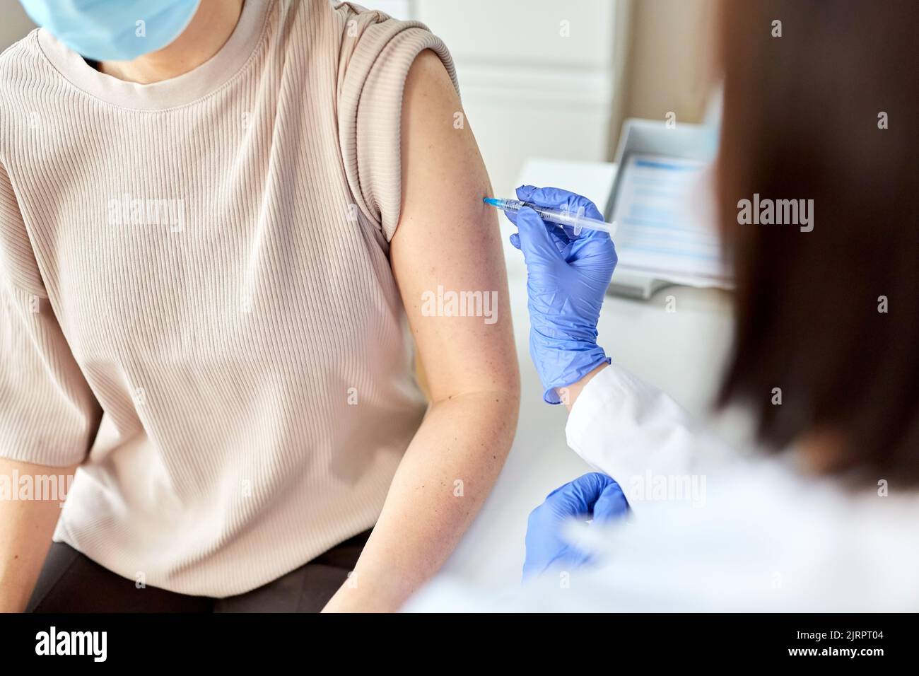 female doctor with syringe vaccinating patient Stock Photo - Alamy
