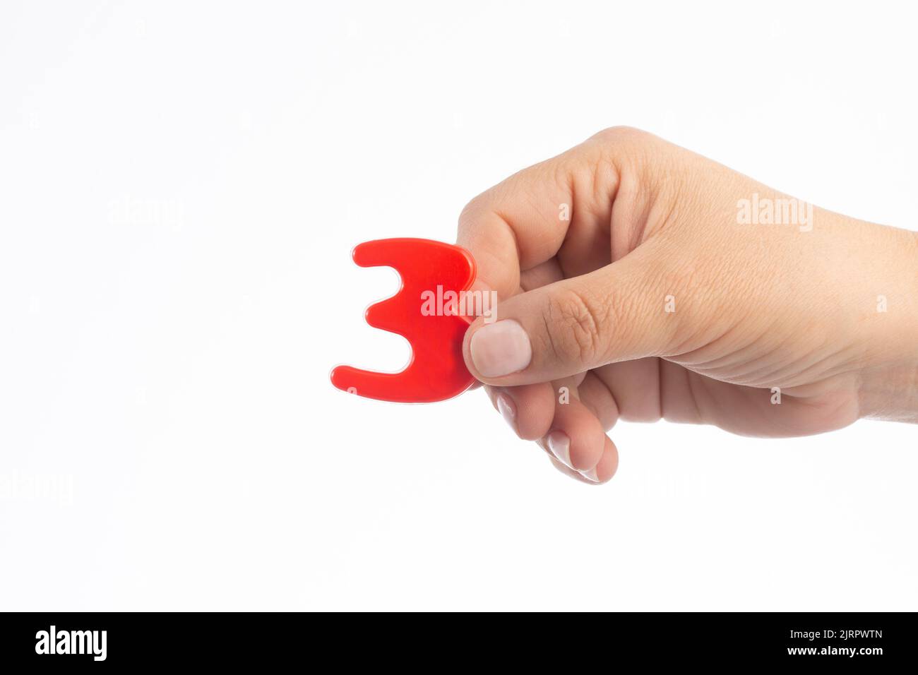 Woman's hand holding plastic number 3 symbol, close up image Stock