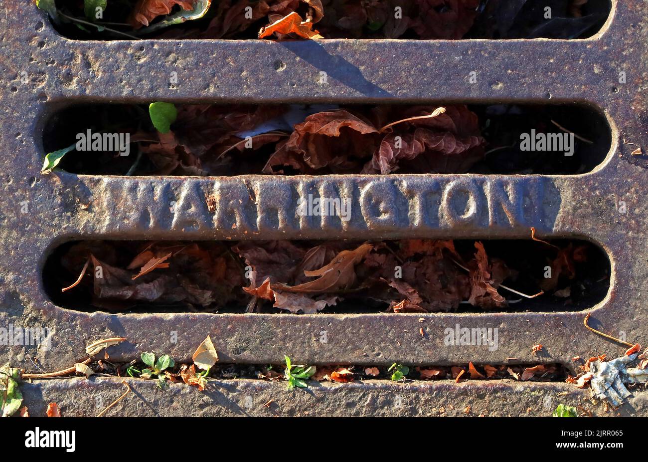 Cast Iron Warrington embossed  cast iron road grids, Cheshire, England, UK, WA1 1NN Stock Photo
