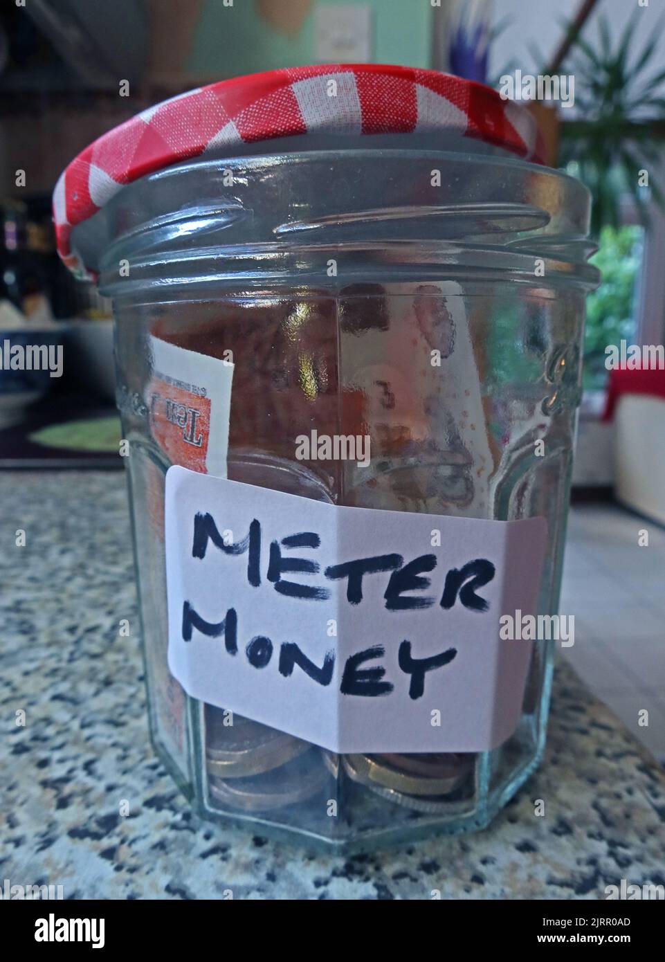 A jar for heating money, to be used to top up a card fuel meter Stock Photo