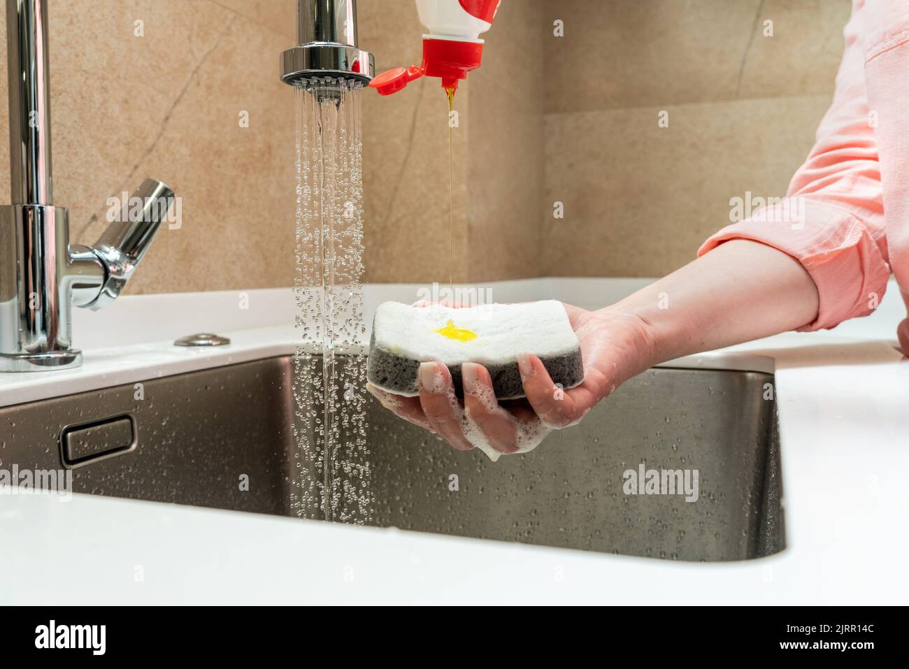 Dishwashing detergent dripping on the buzzer in hand Stock Photo Alamy