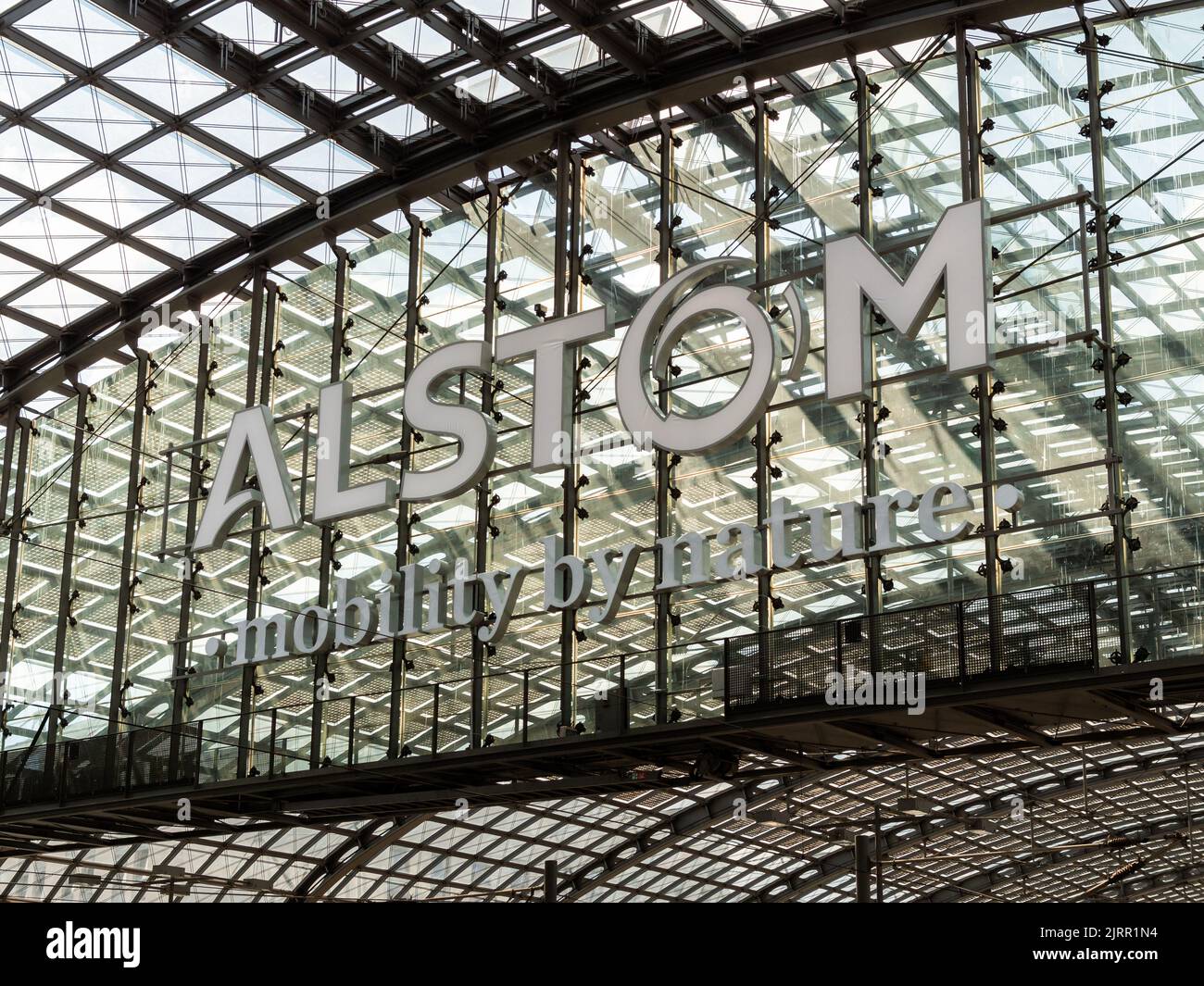 Alstom logo in the main station in Berlin city. White letters on glass and steel facade. Alstom is a rolling stock manufacturer for rail transport. Stock Photo