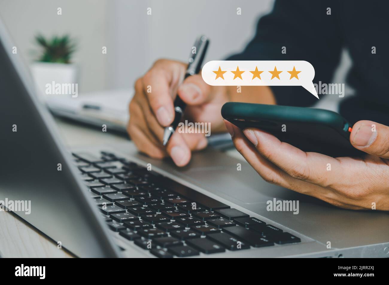 hand businessman holding smartphone and use computer laptop. Customer