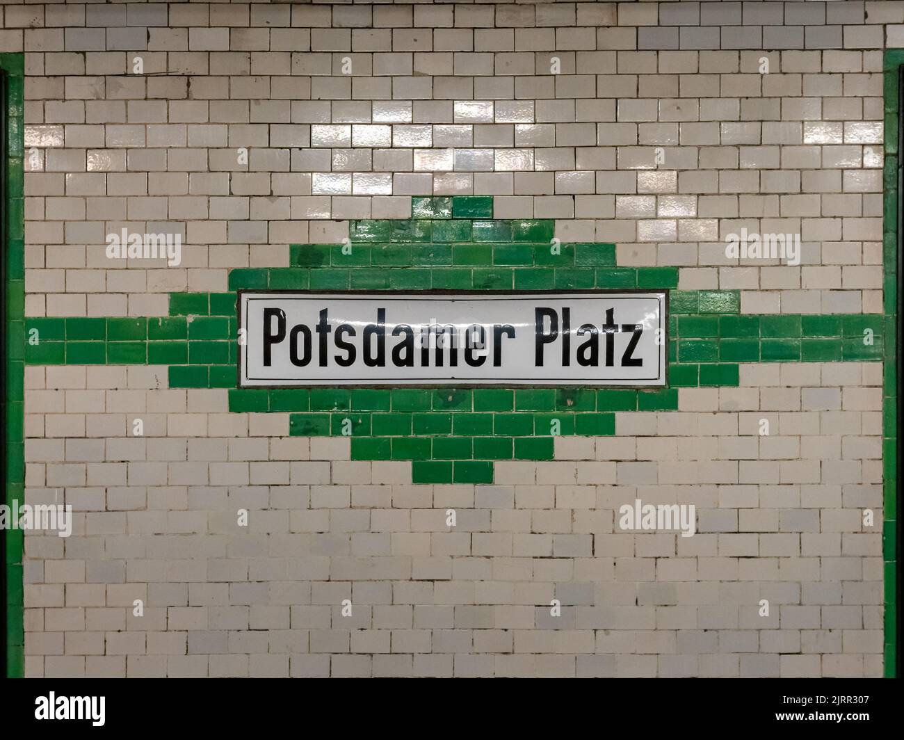 Potsdamer Platz U-Bahn station in Berlin city. Old design with a tiled wall exterior. Black letters on a white board. Subway station name board. Stock Photo