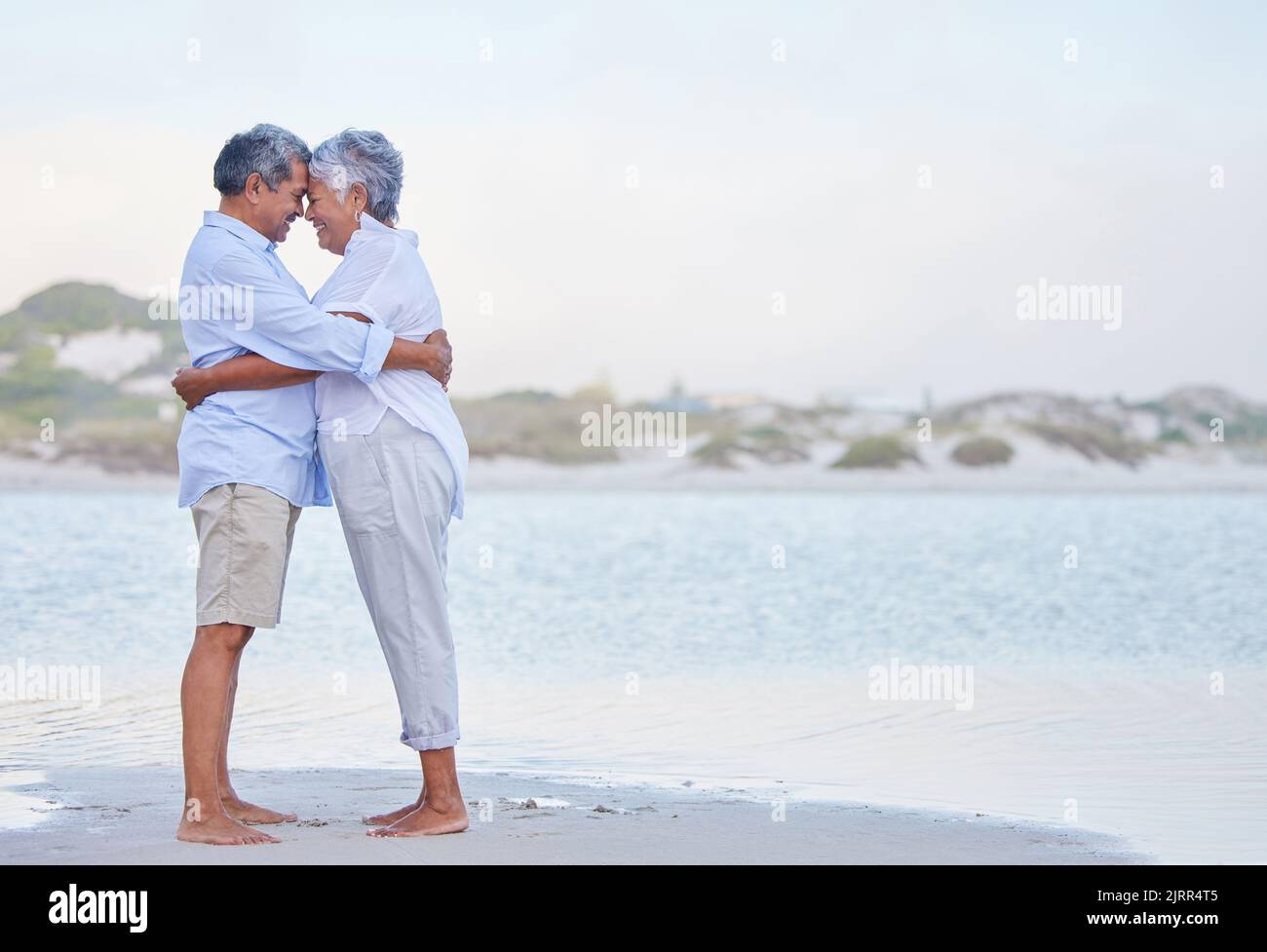 Senior Couple Retirement Beach Holiday And Travel Vacation At Sea With