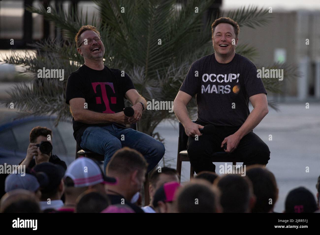 SpaceX Chief Engineer Elon Musk and T-Mobile CEO Mike Sievert share a laugh during a joint news conference at the SpaceX Starbase, in Brownsville, Texas, U.S., August 25, 2022. REUTERS/Adrees Latif Stock Photo