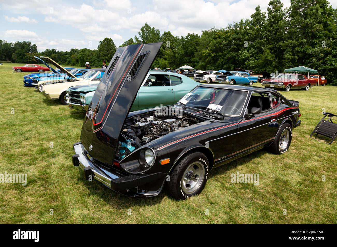 A black Datsun 280Z sports car, also known as the Nissan S30 Fairlady Z, on display at a car show in Fort Wayne, Indiana, USA. Stock Photo