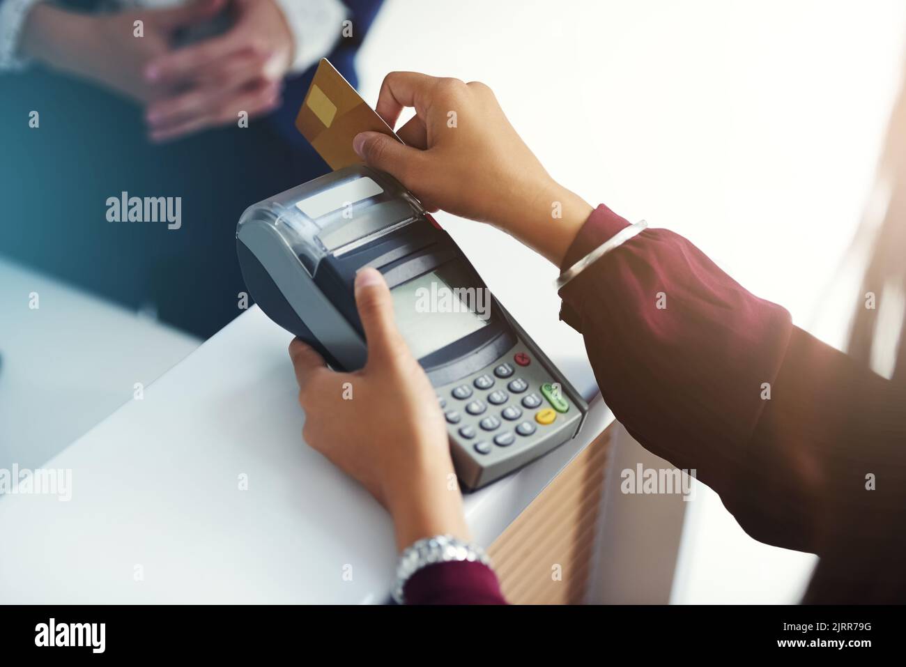 Settling a charge by card. an unrecognisable person swiping a credit card for payment. Stock Photo