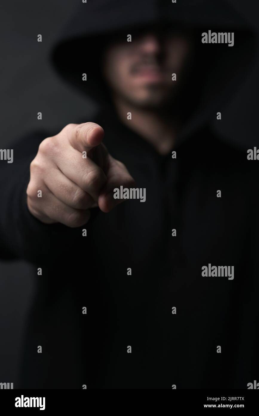 You could be next. an unidentifiable hooded man pointing while standing