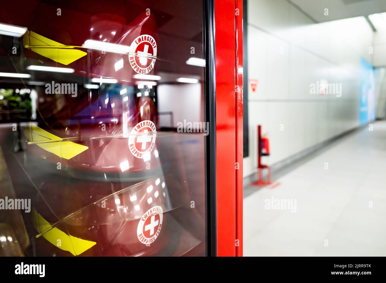 Safety equipment cabinet filled with helmets in public area building Stock Photo