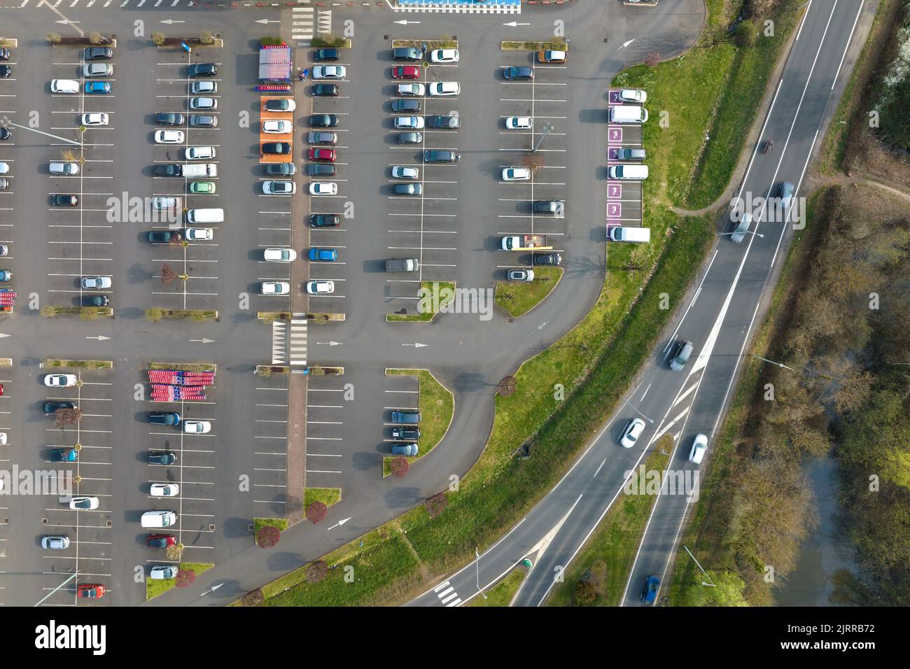 Aerial view of many colorful cars parked on parking lot with lines and