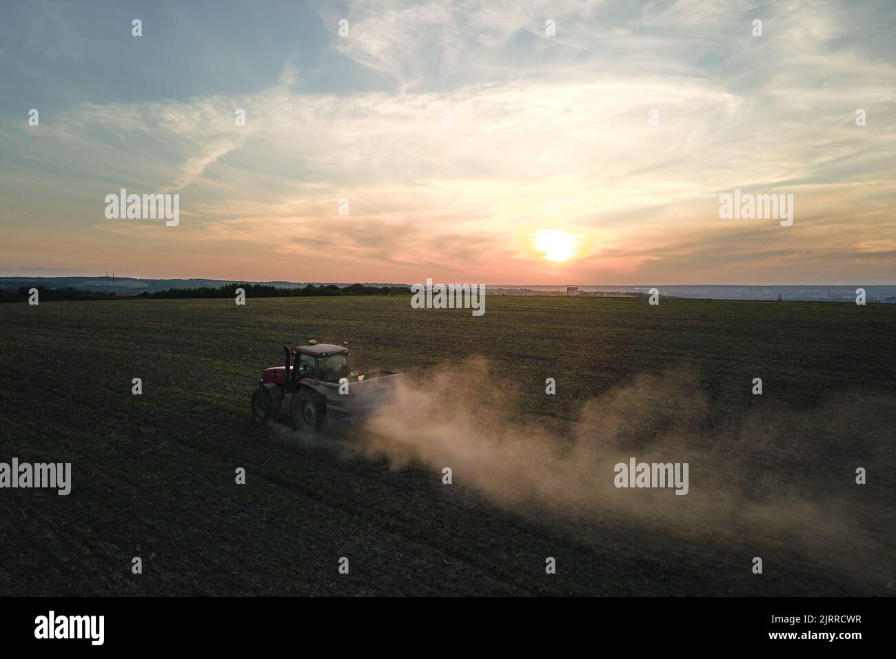 Tractor spraying fertilizers with insecticide herbicide chemicals on