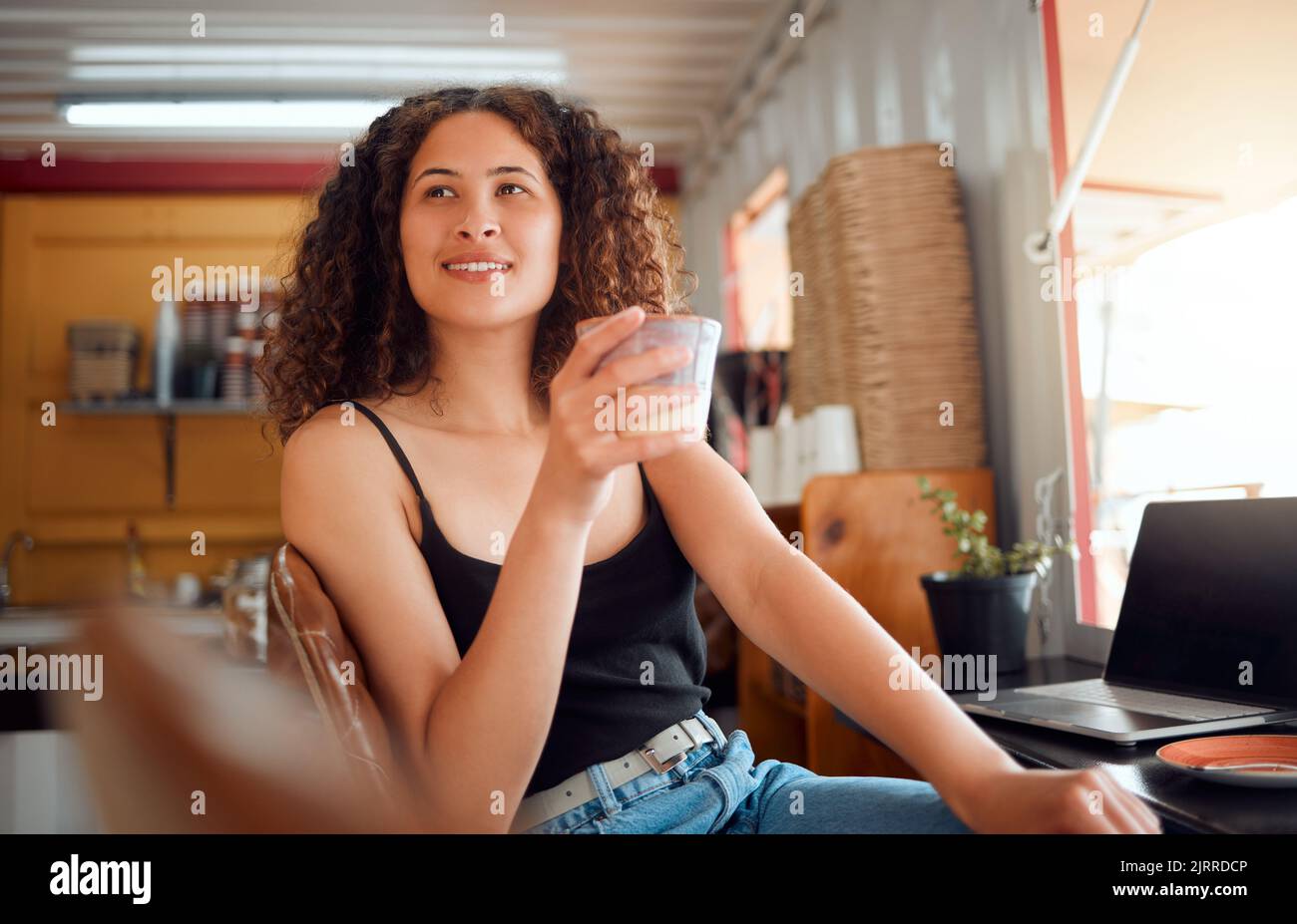 Morning, coffee and relaxed woman in a small business enjoying a warm beverage at work. Attractive young casual remote worker or freelancer thinking Stock Photo