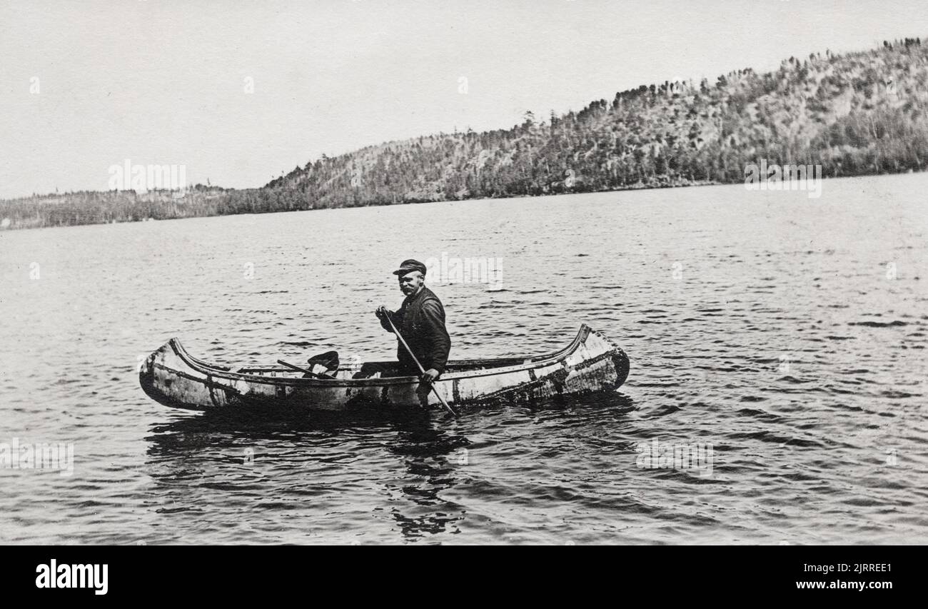 Man in Canoe, unknown location, approx 1910-20's postcard.  unidentified photographer Stock Photo