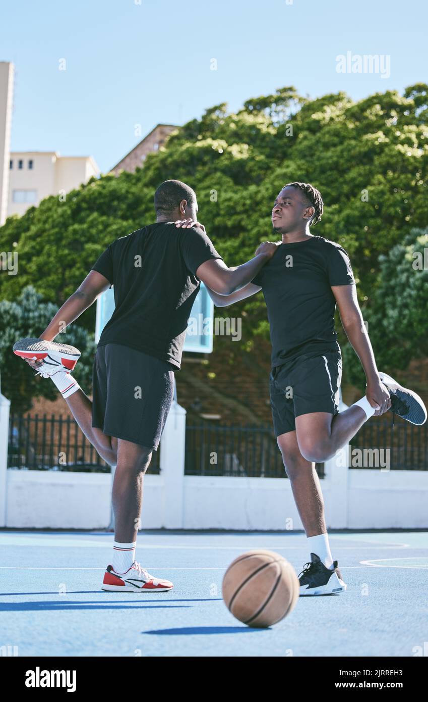 Fit, active and sporty young basketball players stretch or warm up