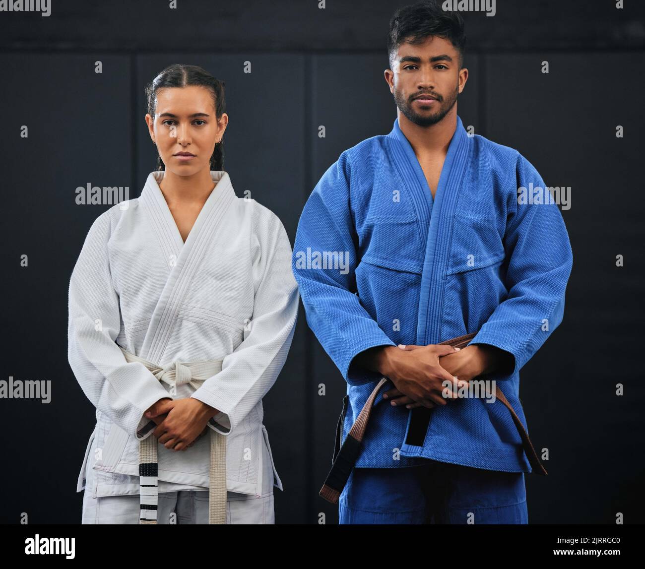 .Fitness, motivation and discipline karate training with a student and teacher standing proud in a center or dojo. Young woman learning defense Stock Photo