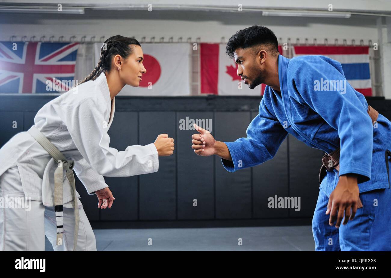 Karate, mma and fitness with a teacher and student learning, training and doing a workout for exercise, sport and health. Man and woman in fight Stock Photo