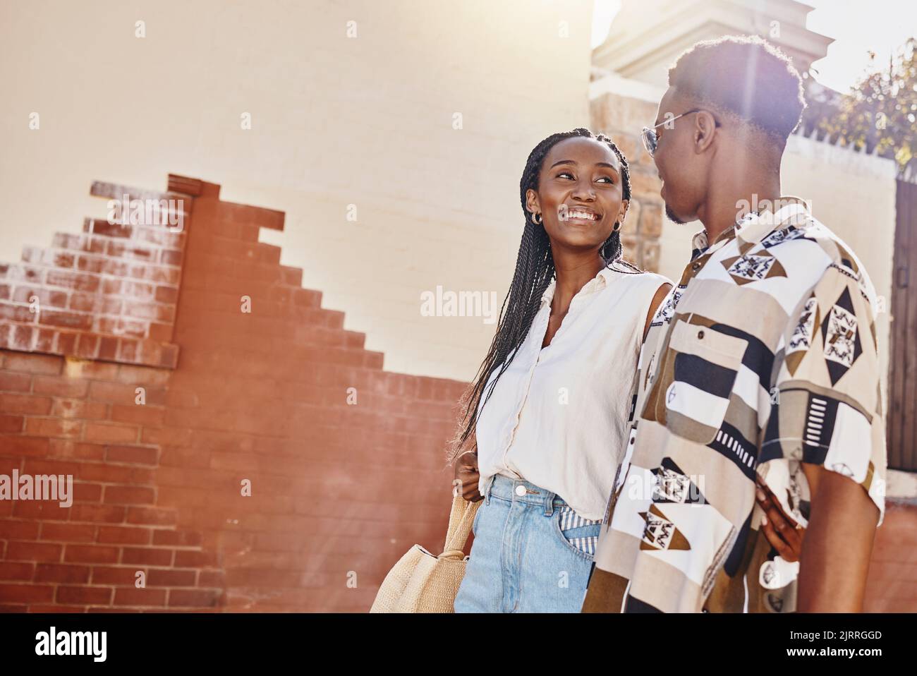 Happy, love and relax couple walking in city on a date together on their getaway break. Summer, travel and smile with young black man and woman Stock Photo