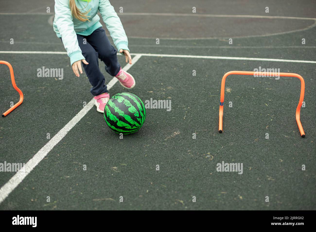 Relay for children. Sports game. Children roll meat around playground