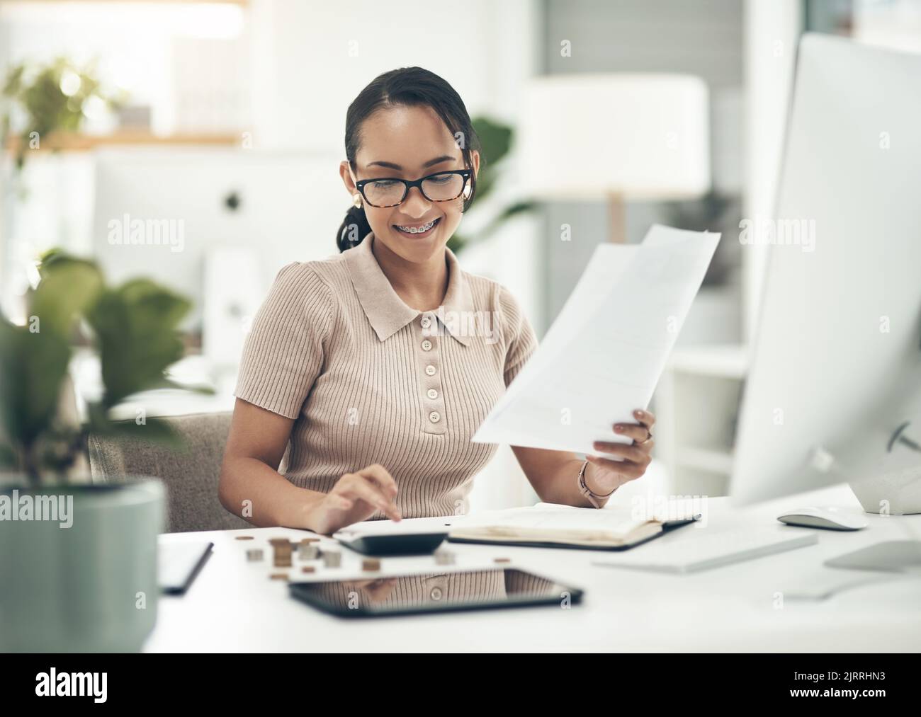 Finance intern, career or financial employee learning her banking budgeting on a calculator. Young accountant, money insurance advisor or investment Stock Photo