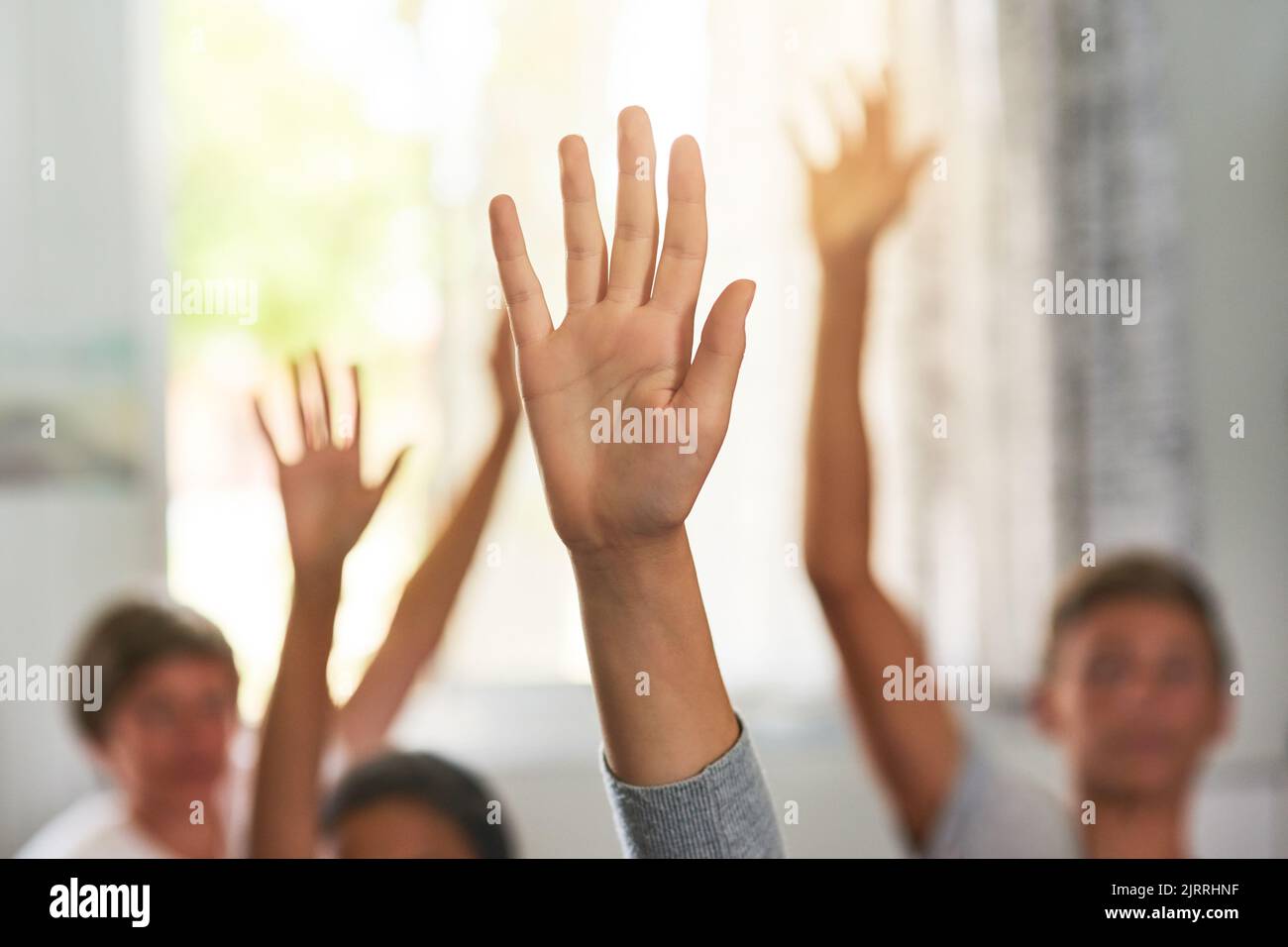 Whos ready for recess. unidentifiable schoolchildren raising their