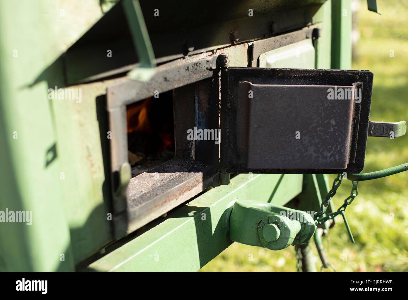 Wood burning stove. Door of outdoor stove is used as field kitchen