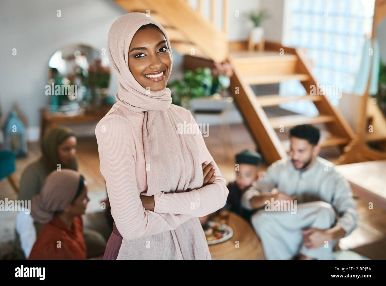 Muslim islam woman on EID with family at house in .Pakistan, Saudi Arabia or Iran to celebrate ramadan. Young girl smile in hijab with food in Stock Photo