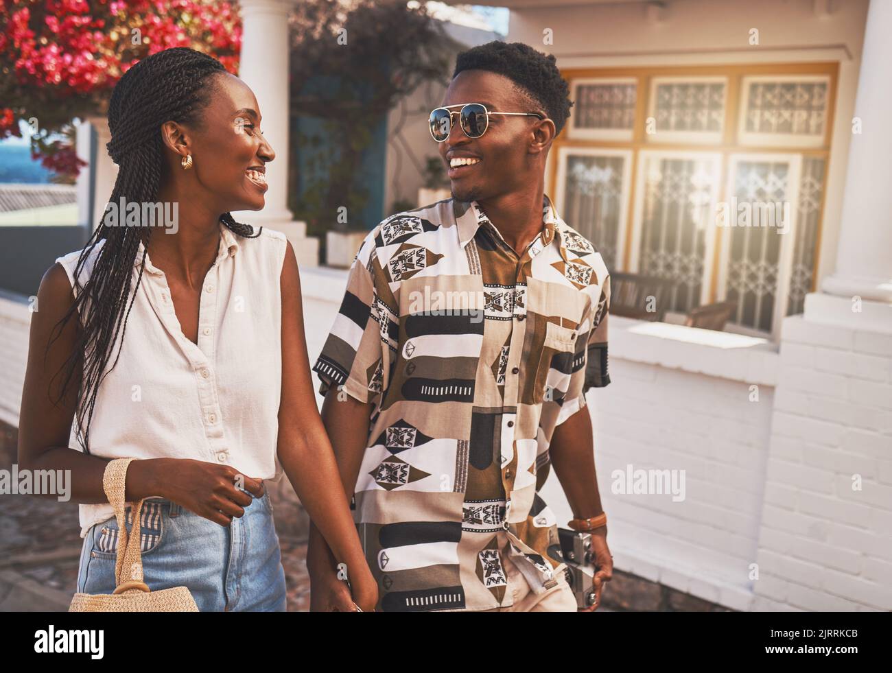 Happy, relax and in love couple walking in small town or city street on their holiday date in spring time. Travel, summer and smile man and woman Stock Photo