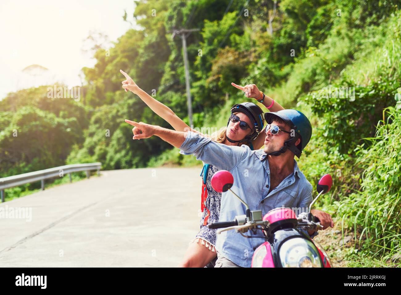 Seeing the sights their favourite way. a happy young couple exploring an exotic destination by scooter. Stock Photo