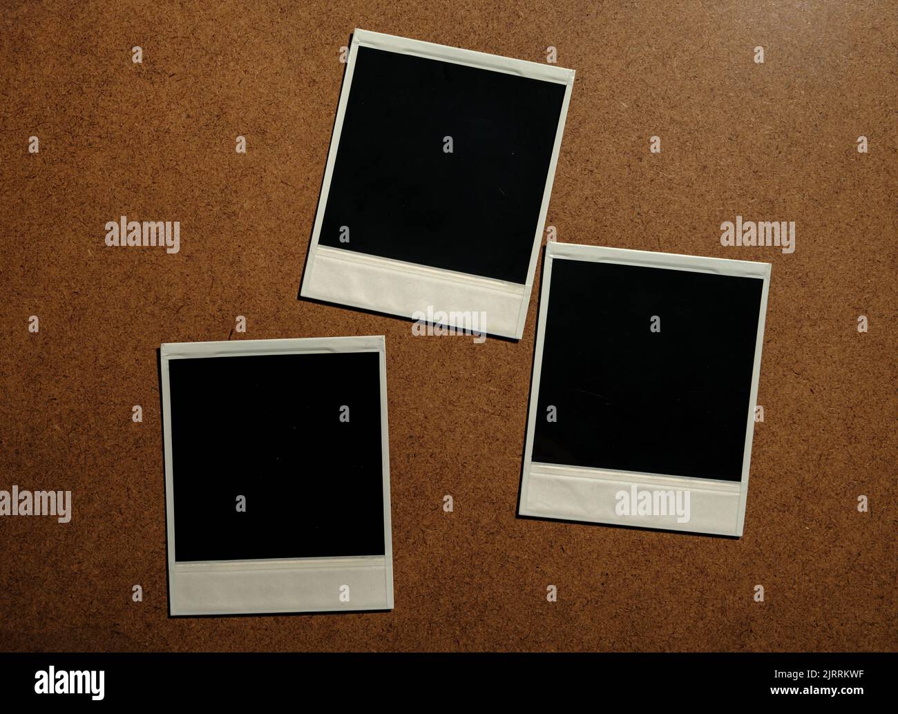 Three blank photo frames on brown table Stock Photo