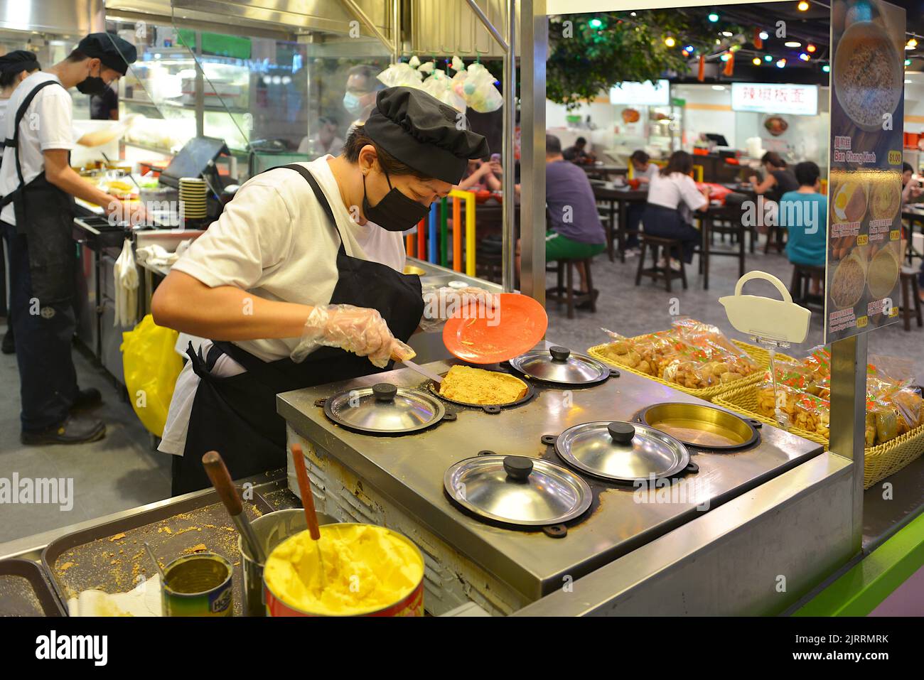 A lady preparing Chinese Peanut Pancake, Ban Chang Kueh, a popular