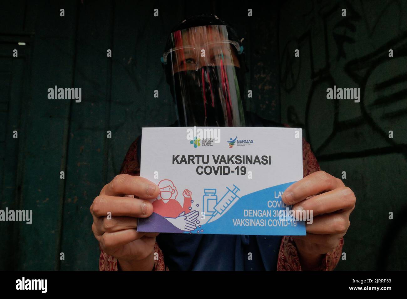Temanggung, Central Java, Indonesia, Sept 23, 2021: citizen showing vaccine card. Through this method, vaccination participation is expected to increase because it can reach families who do not have access and are afraid to leave the house to avoid transmitting the virus. Stock Photo