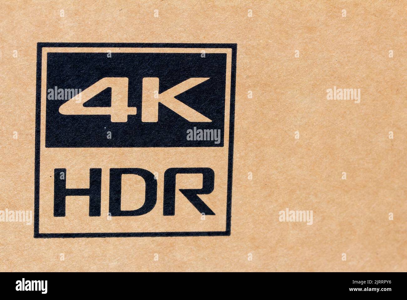 Sign over electronics package indicating support of 4k resolution. Label indicating support of 4K high dynamic range Stock Photo