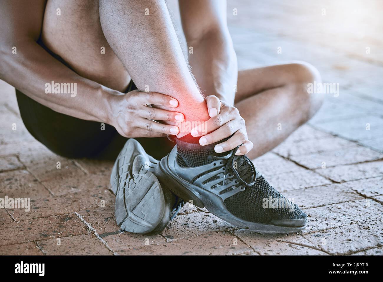 Runner with medical sports running injury and swollen ankle pain. Male athlete treating foot