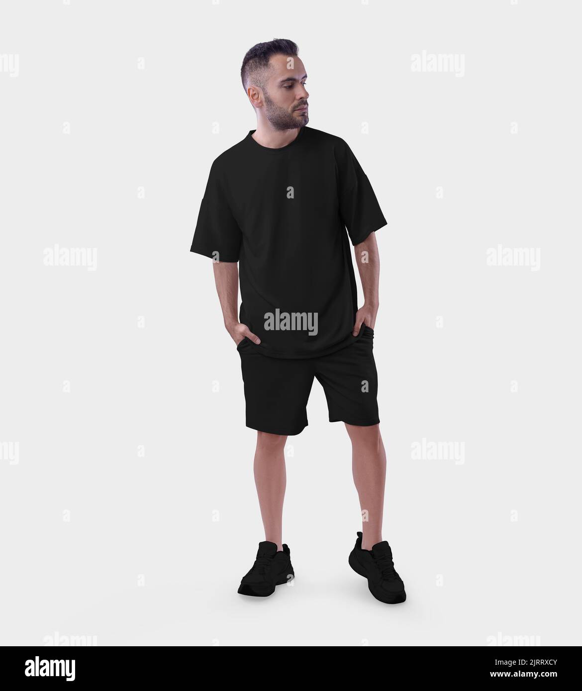 Mockup of a black oversize suit on a guy in sneakers, with his hands in his pockets, isolated on background. T-shirt template, shorts with a loose fit Stock Photo