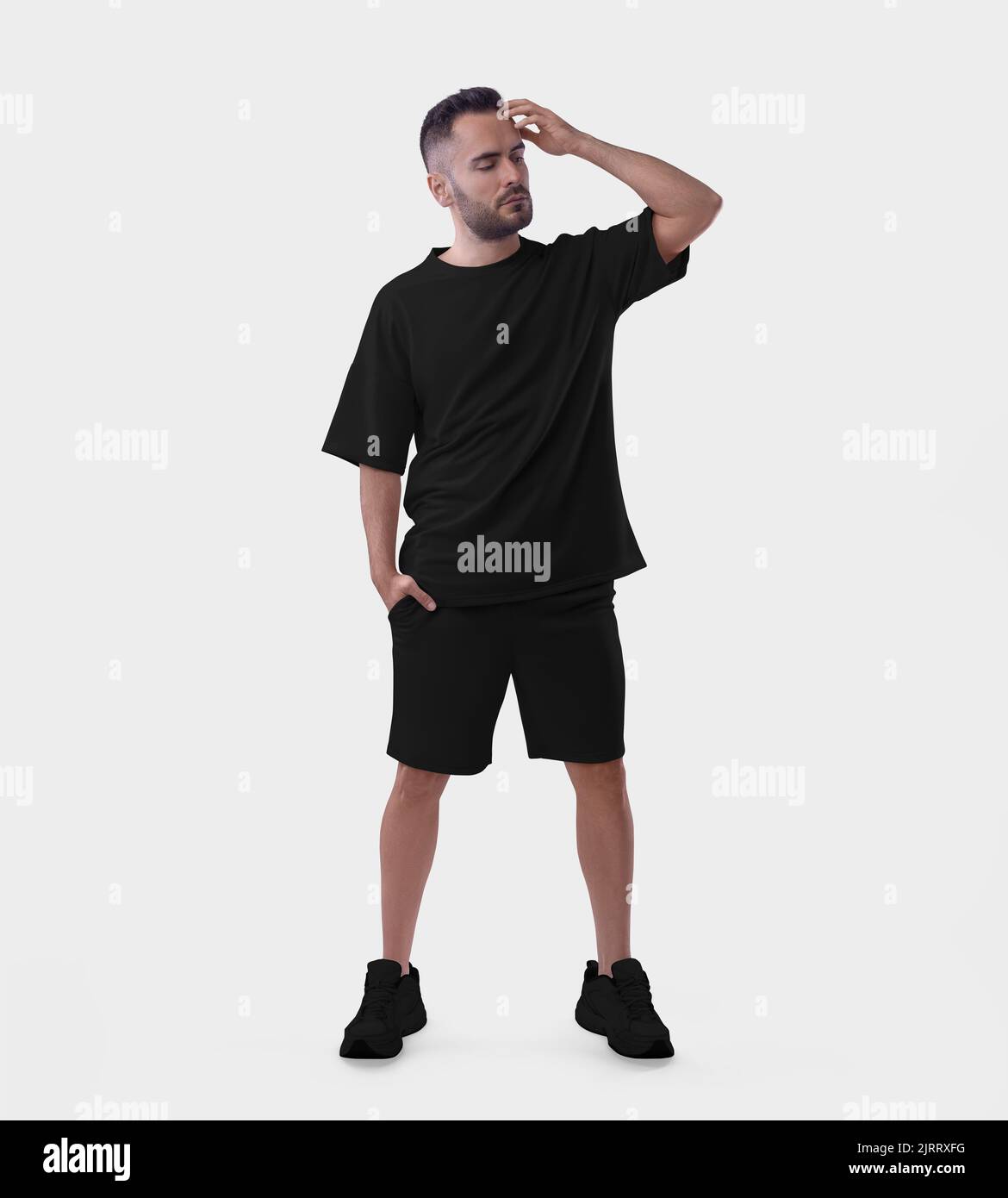 Oversized black suit mockup on a bearded guy in sneakers fixing his