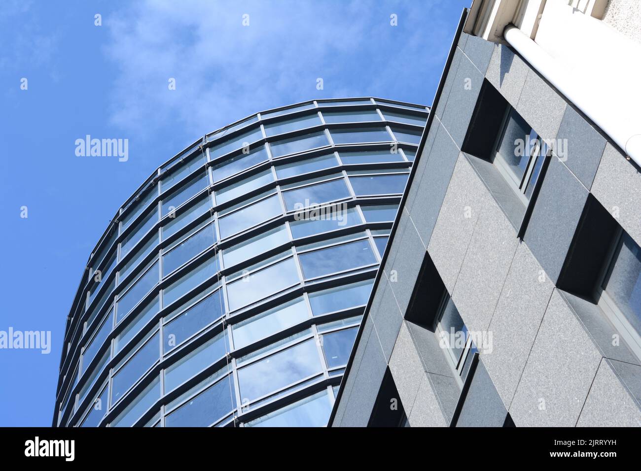 a modern building with a blue sky with clouds above it Stock Photo - Alamy
