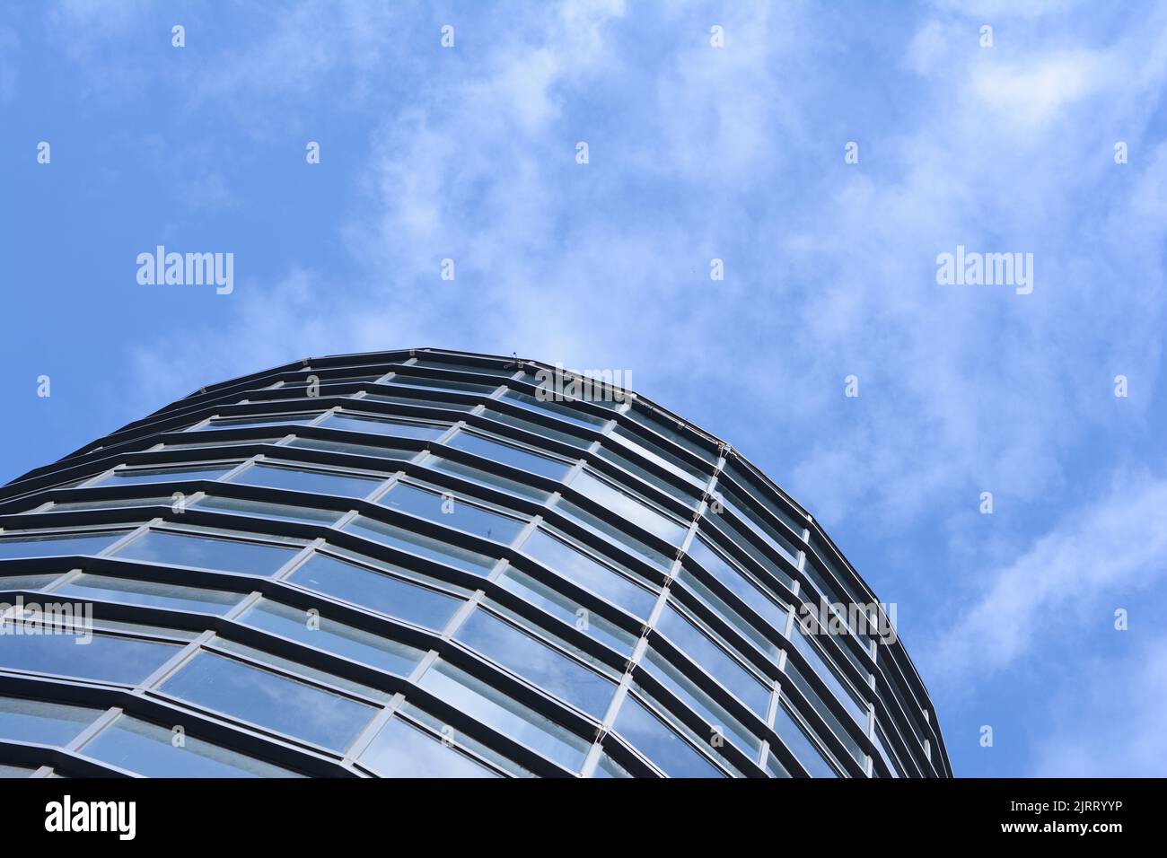 a modern building with a blue sky with clouds above it Stock Photo - Alamy