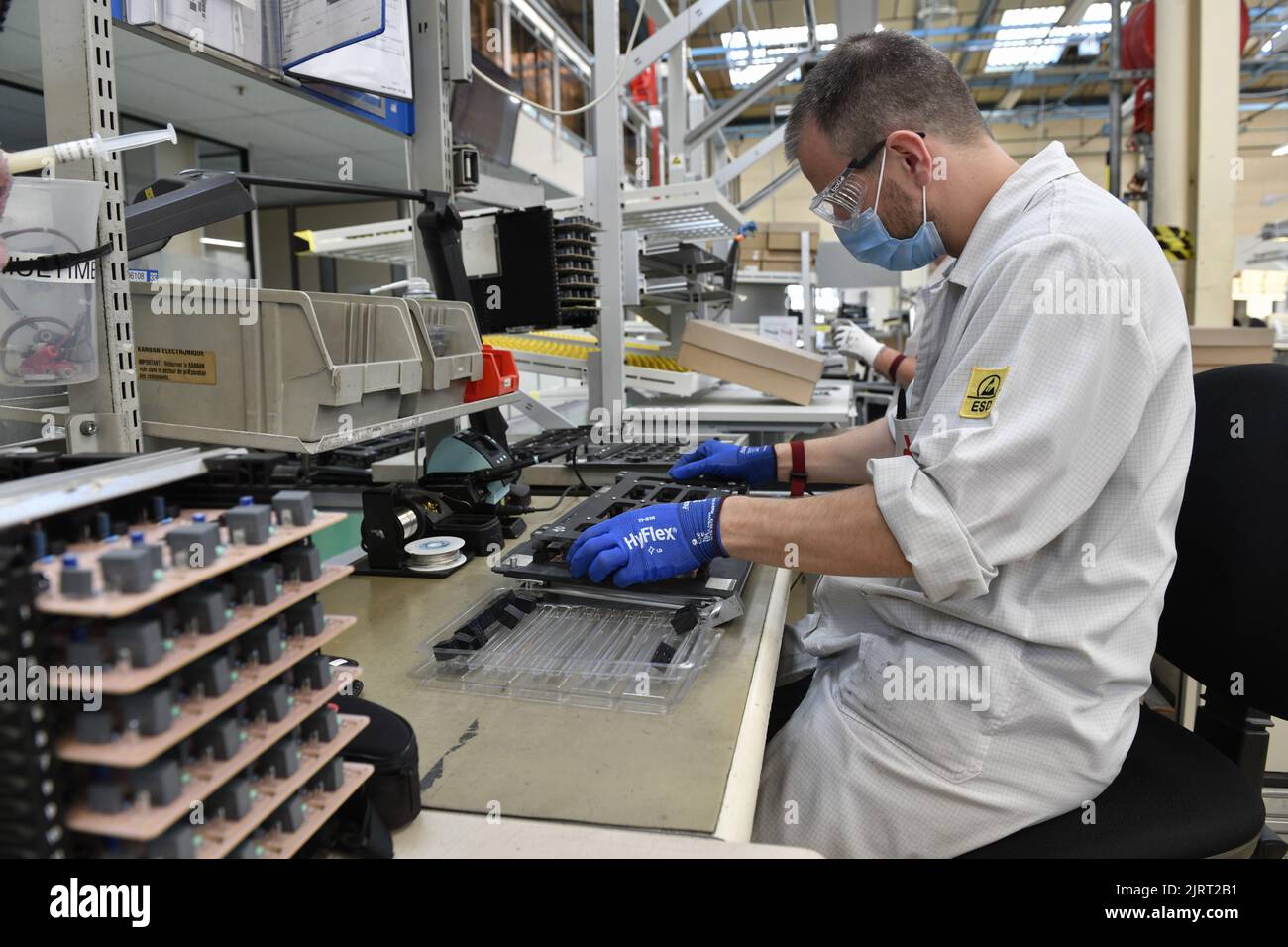 Saint-Lo (Normandy, north-western France), 2021/09/16: employee wearing a lab coat working in the Electronic Development Center of Groupe SEB, the wor Stock Photo