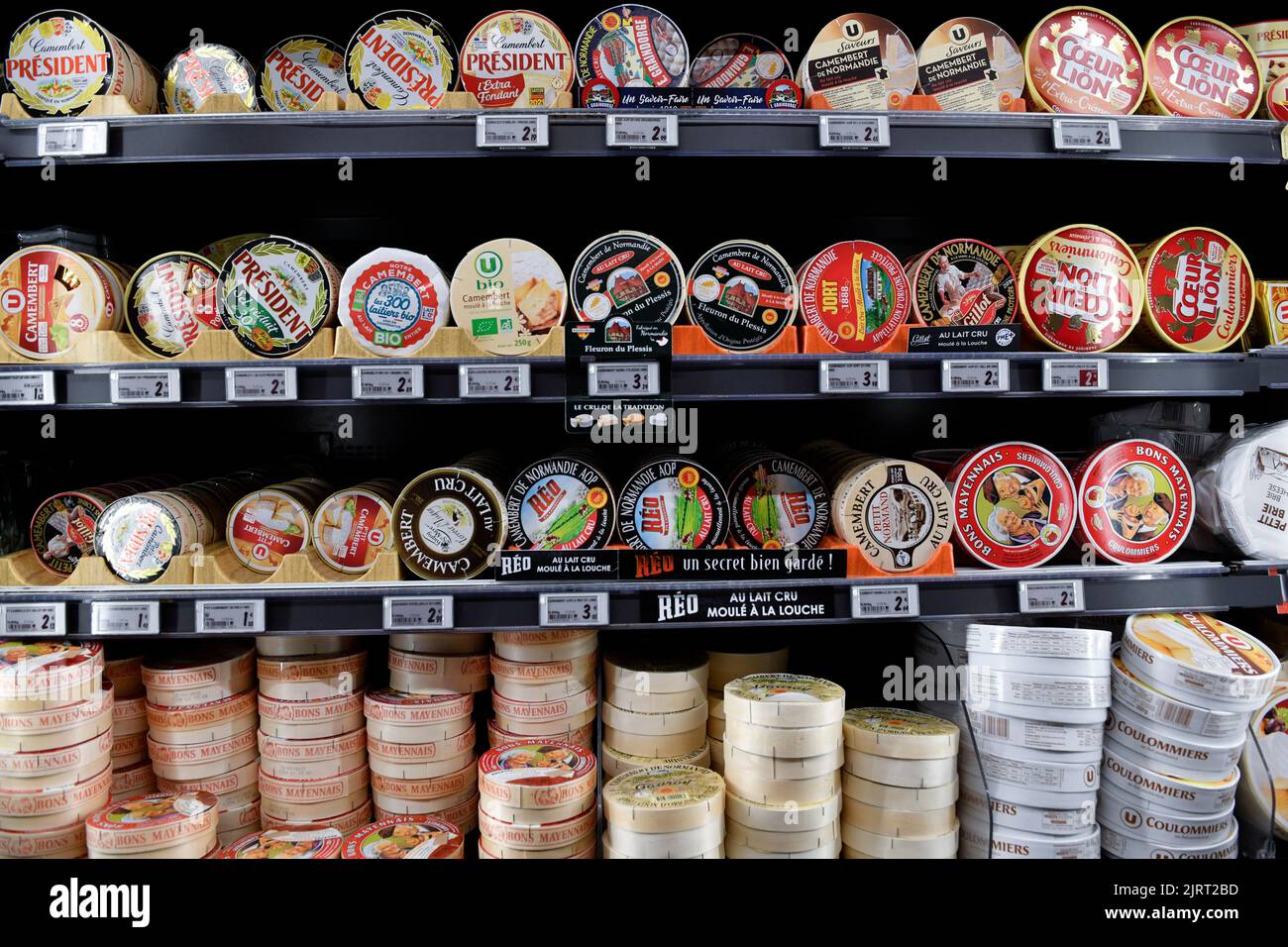 Camemberts in the cheese counter Super U supermarket Stock Photo