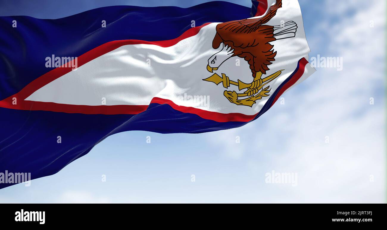 The American Samoa flag in the wind on a clear day. American Samoa is an unincorporated territory of the United States located in the South Pacific Oc Stock Photo