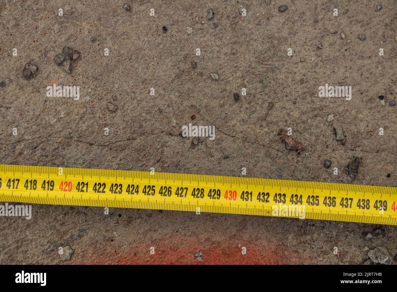 Measuring ruler on a concrete wall texture. The concept of renovation ...