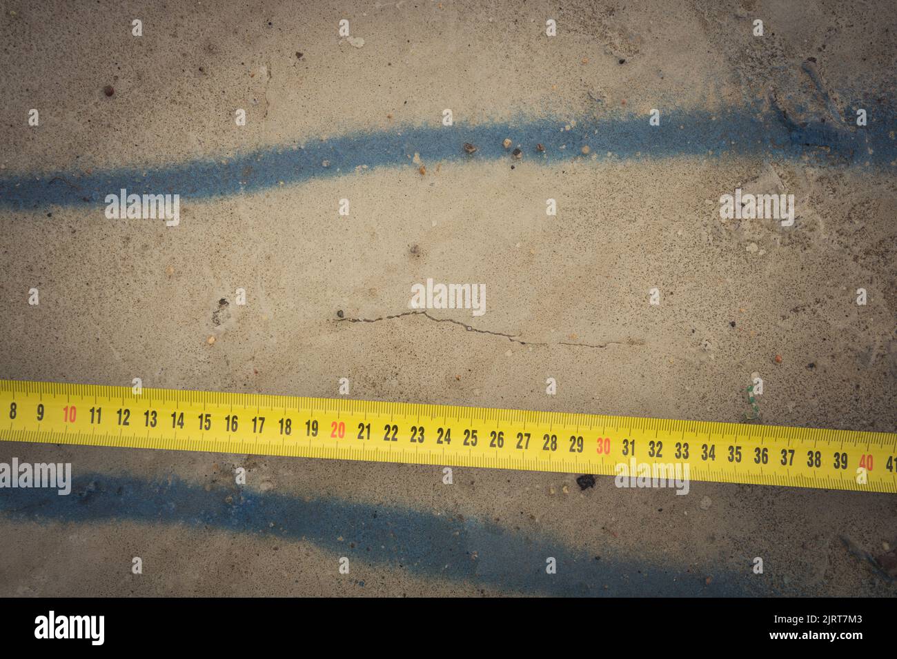 Measuring ruler on a concrete wall texture. The concept of renovation ...