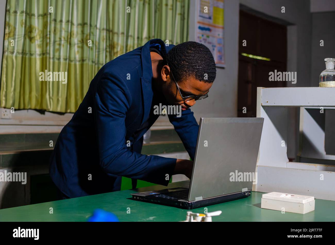 guy working on his laptop in the lab Stock Photo