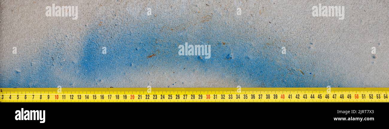Measuring ruler on a concrete wall texture. The concept of renovation ...