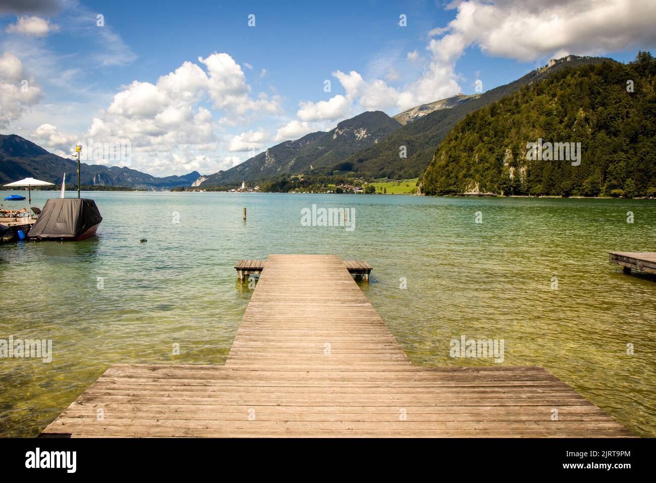 Beautiful view of Lake Wolfgang (Wolfgangsee), Strobl - Austria, Europe. Wooden pier in the foreground. Perfect HD wallpaper, Awesome 4k background. Stock Photo