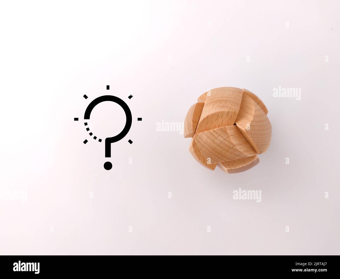 A wooden brain teaser puzzle with solution and question icons on a white background Solution