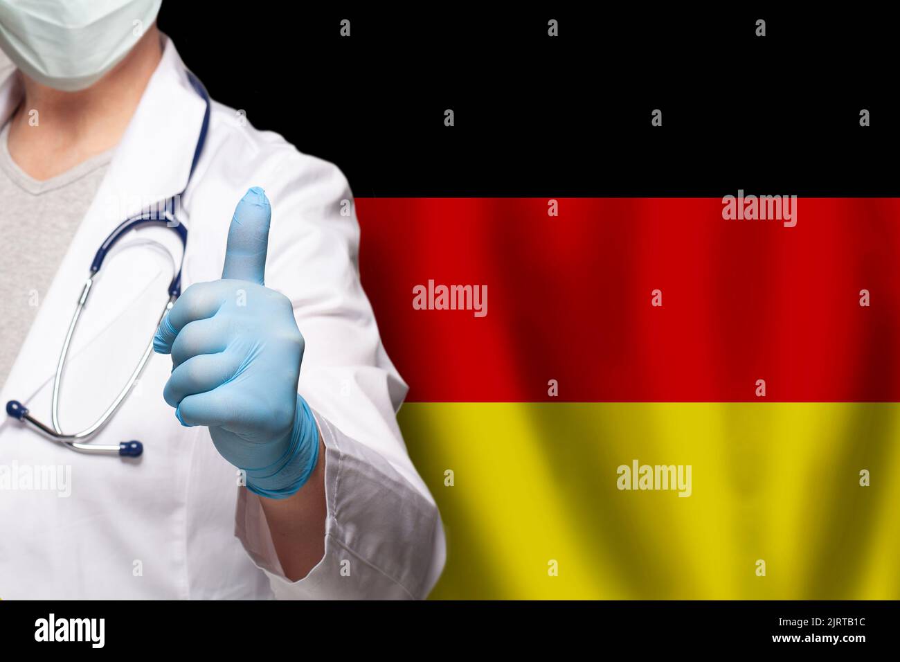 German doctor's hand showing thumb up positive gesture on flag of