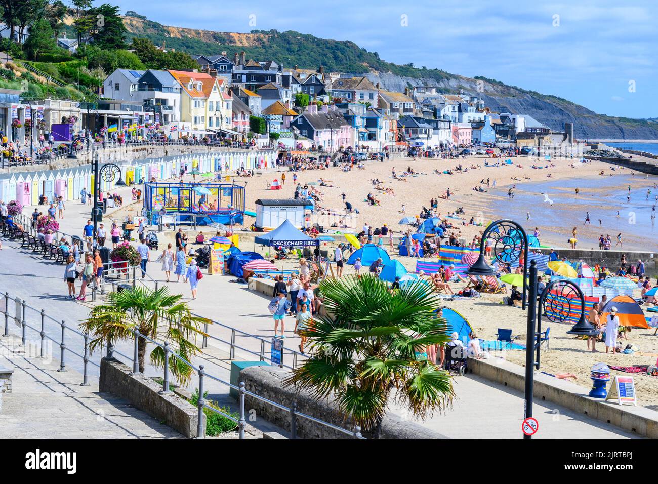 Lyme Regis, Dorset, UK. 26th Aug, 2022. UK Weather: Holidays and sunbathers flock to the busy beach at the seaside resort of Lyme Regis to bask in scorching hot sunshine as the summery weather returns in time for the August Bank Holiday Weekend. Credit: Celia McMahon/Alamy Live News Stock Photo